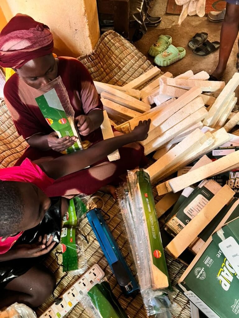 A member of the production team sliding cured Jukye bars into their printed green sleeves